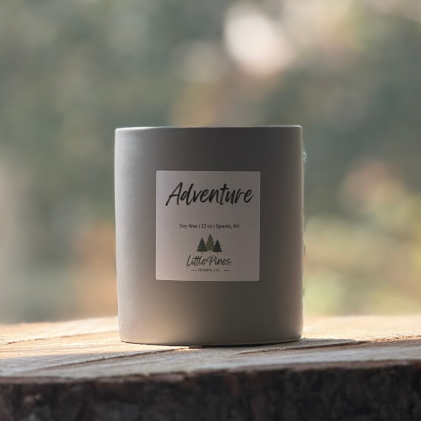 Adventure candle in stone grey ceramic vessel on wood with green background